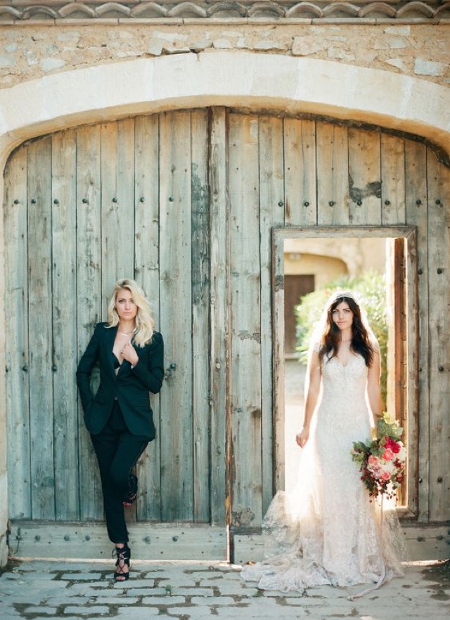 Bride wears black tux while the other bride wears a white bridal gown