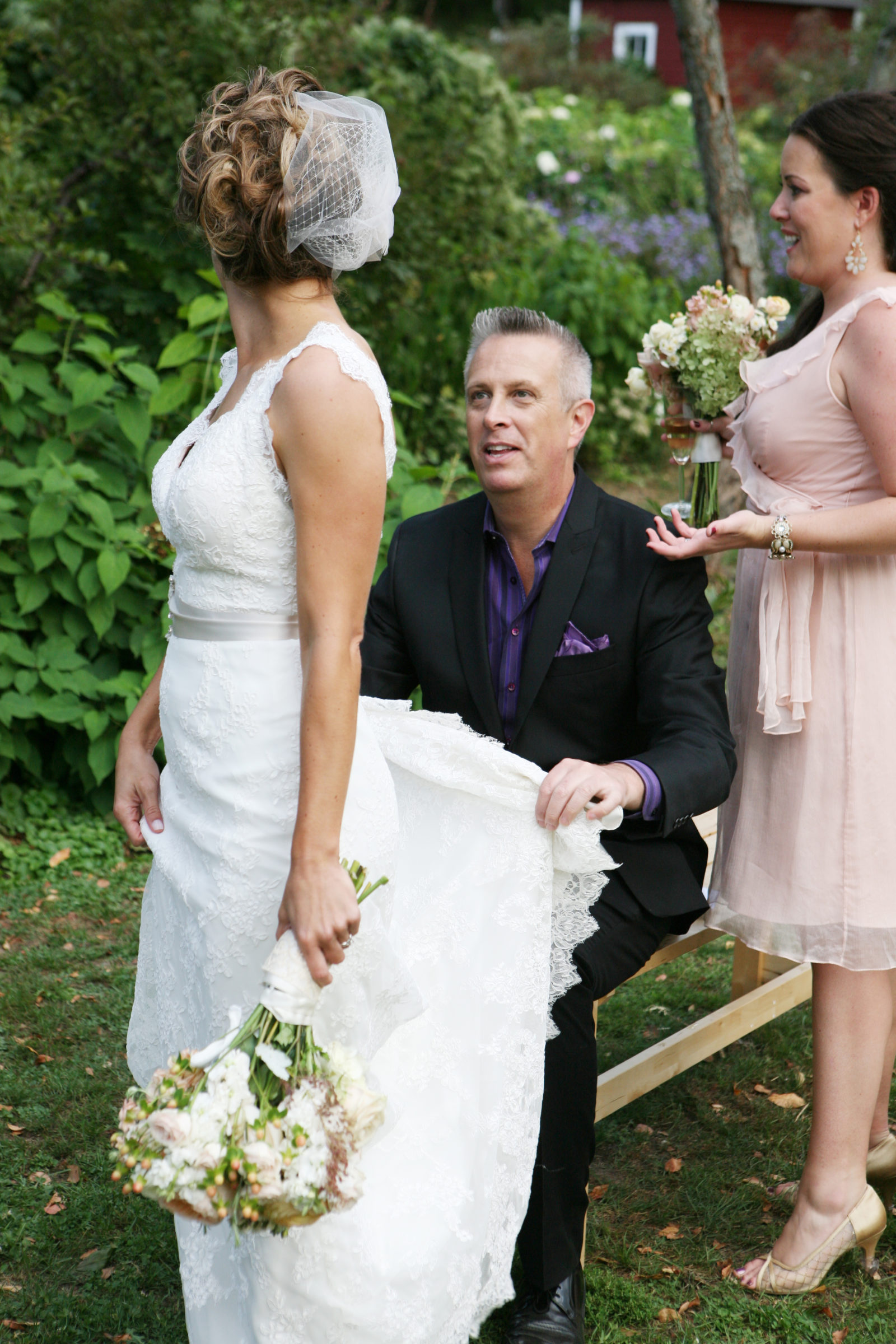 Wedding Guy Bruce Vassar helps bride with dress train