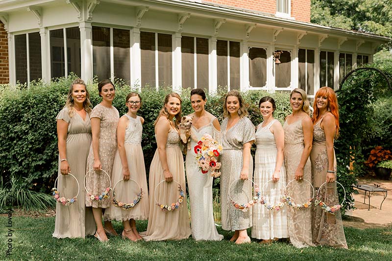 Bridesmaids in assorted neutral gowns