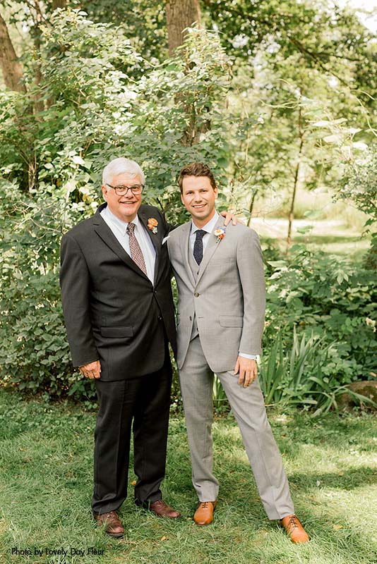 Father of the groom in a black suit with a patterned tie