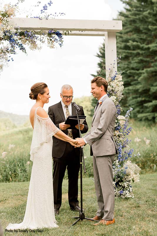 Bride and groom exchange vows at outdoor Minnesota wedding ceremony