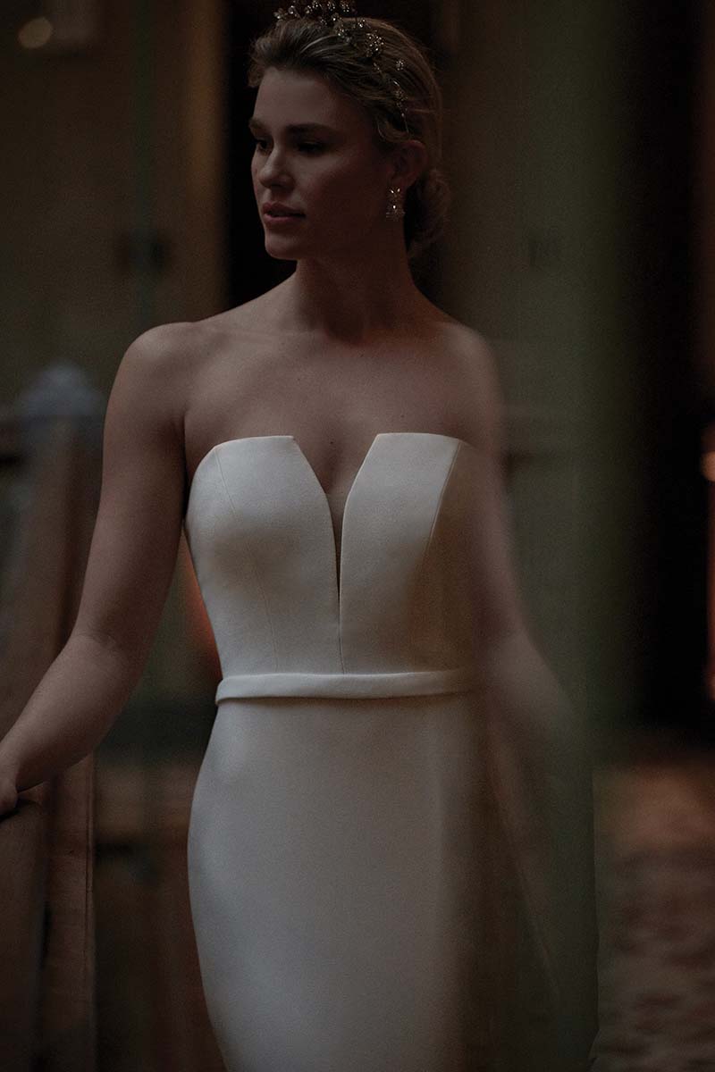 Modern and sleek wedding gown with deep v by Justin Alexander