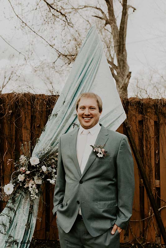 Groom with blue triangle backdrop