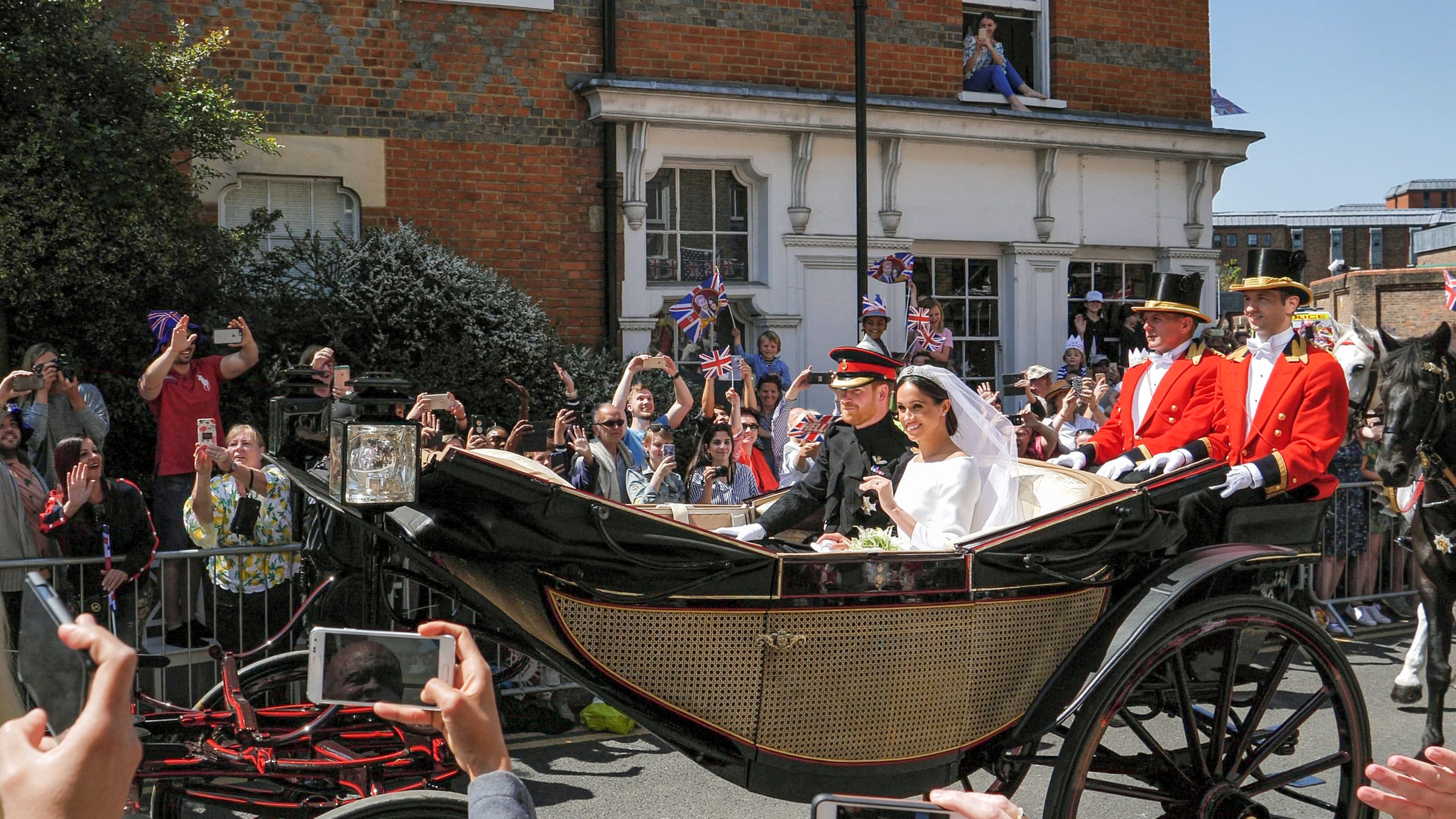 Prince Harry and Meghan Markle greet fans in carriage following royal weddings 