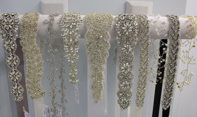 Rhinestone bridal sashes on display at Looking Sharp Alterations