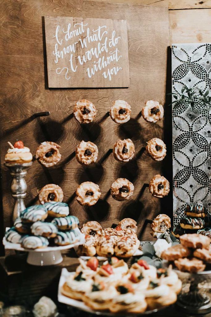 Donut wall at wedding dessert table