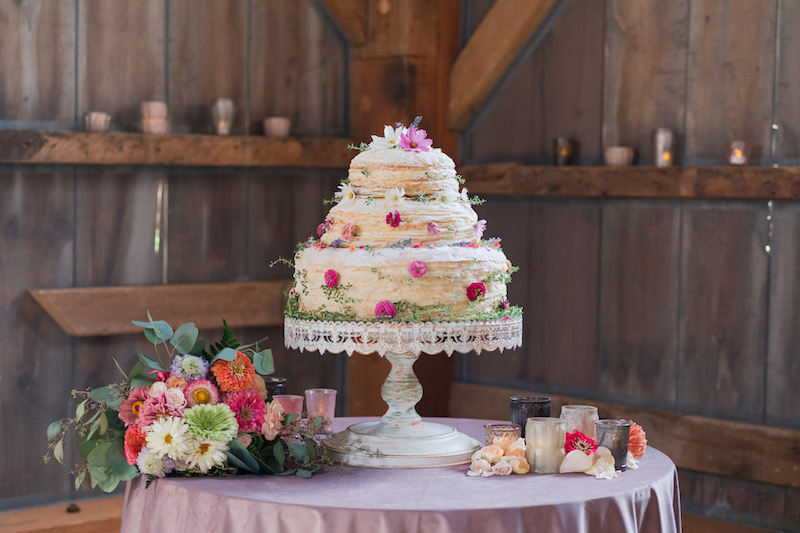 3-tier spring wedding cake with floral additions