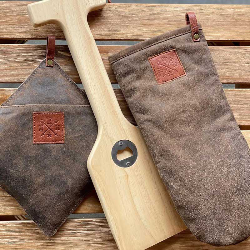 Grill scrapper and brown oven mitts