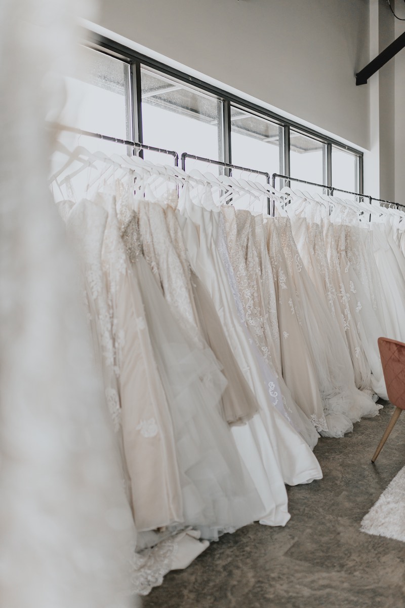 Wedding gowns on rack at Luxe Bridal Couture in Rochester