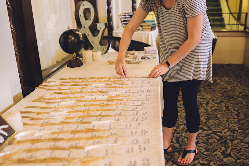 Your Day Coordinations wedding planner sets up table numbers at wedding
