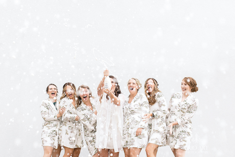 Bridal party pops champagne by Brio Art Photography