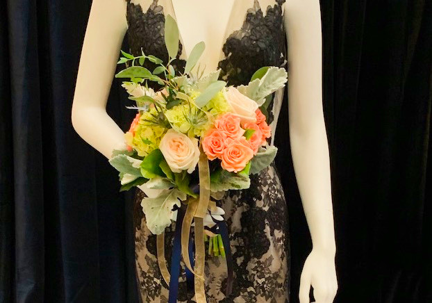 Black bridal gown with peach and pink wedding floral bouquet