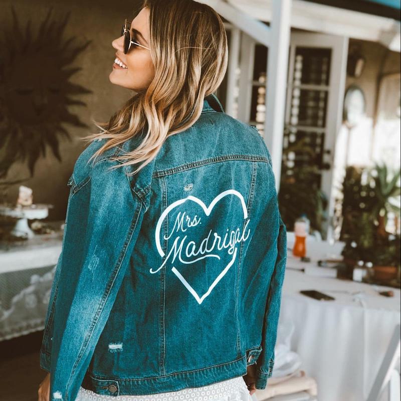 Bride in custom "Mrs" jean jacket by Shades of Pink boutique