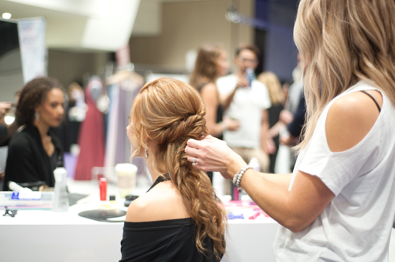 Model gets hair done before Twin Cities Bridal Show 