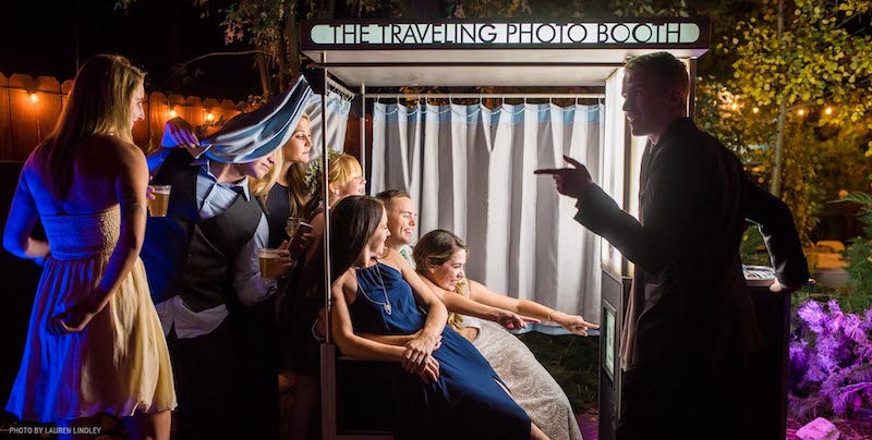 Wedding party takes photos in photo booth