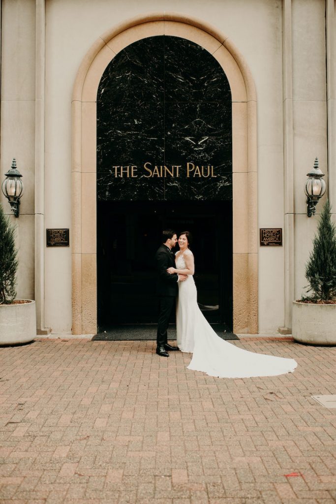 Bride and groom stand outside Minnesota luxury wedding venue