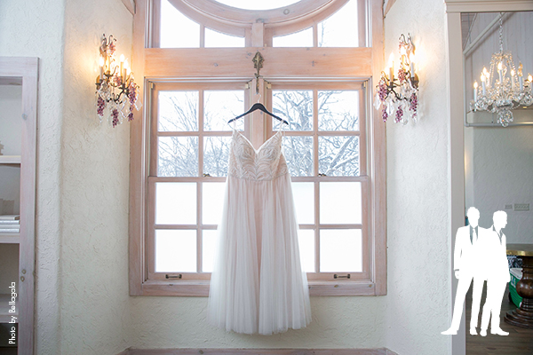 Elegant white wedding dress on hanger