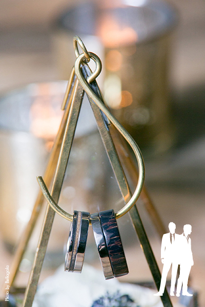 Black and silver wedding bands on hanging hook
