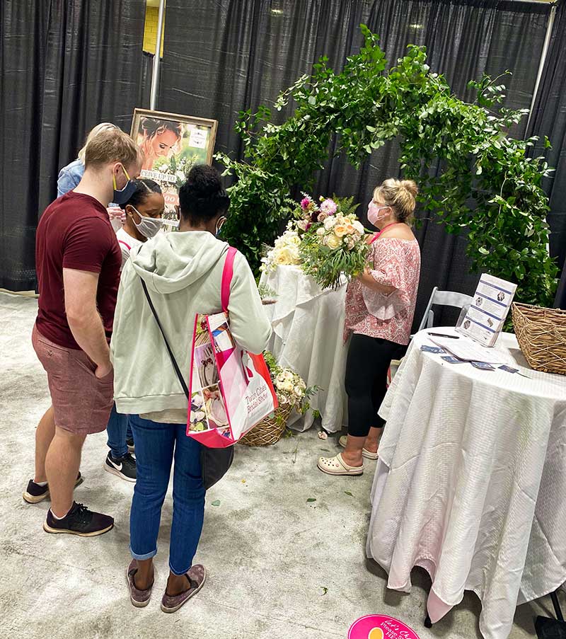 Couple meets with wedding vendor at 2020 Twin Cities Bridal Show