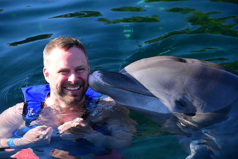Man takes a swim with dolphin