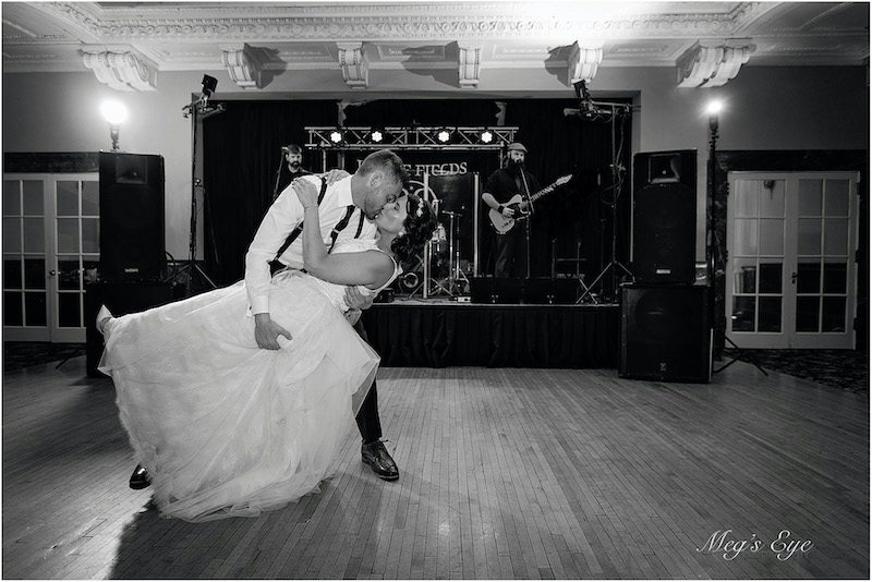 Bride and groom dance to live band at wedding