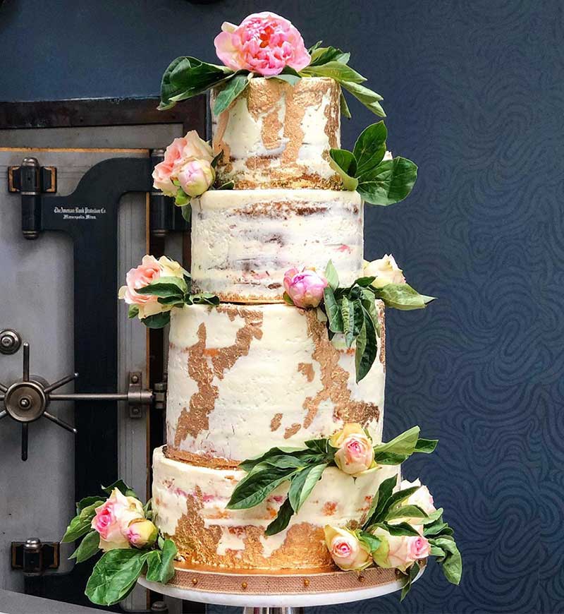 Naked wedding cake with pink flowers by JohnJeanJuan