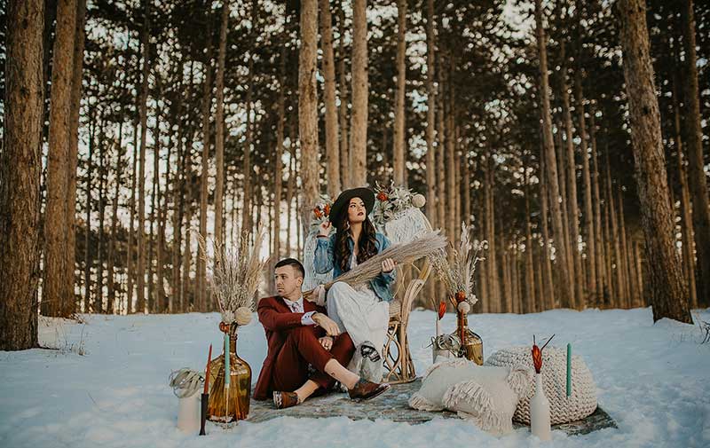 Boho couple poses for winter outdoor styled shoot