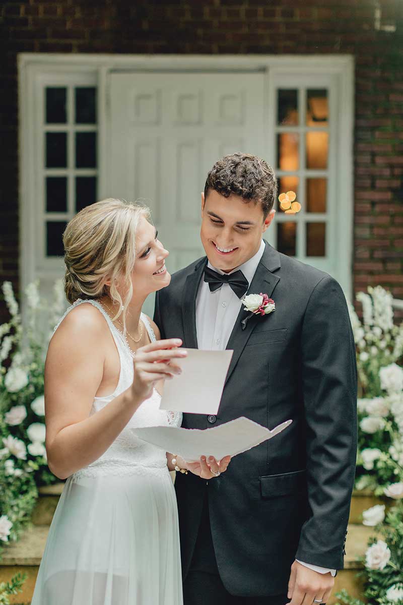 Bride and groom look at wedding invites