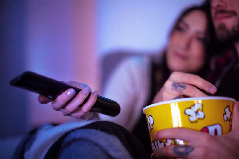 Couples watches movie for at-home date night idea
