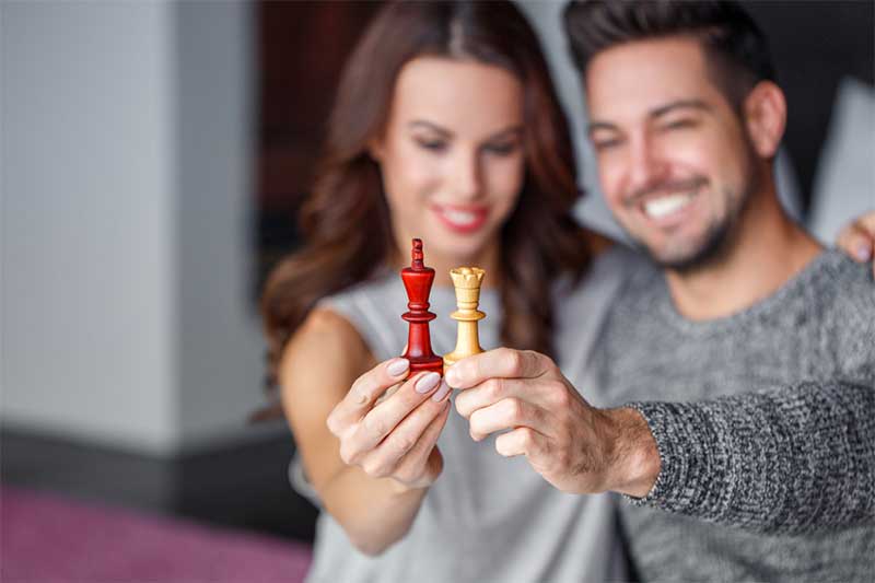 Couple holds chess pieces