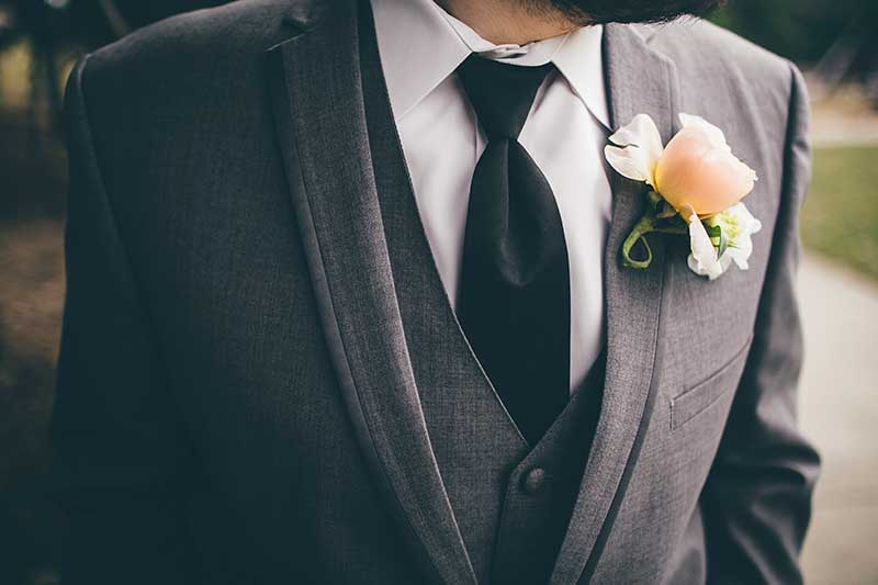 Gray tuxedo with yellow and white boutonnière 