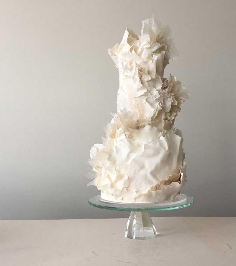 Modern white wedding cake with with sugar flowers