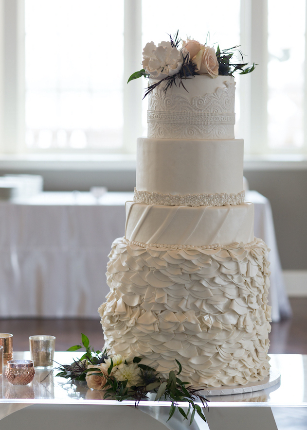 4-tier intricate white wedding cake