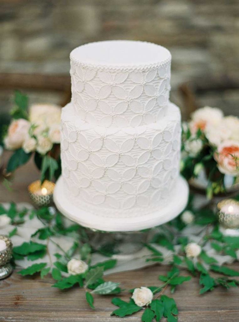 Piped lace white wedding cake