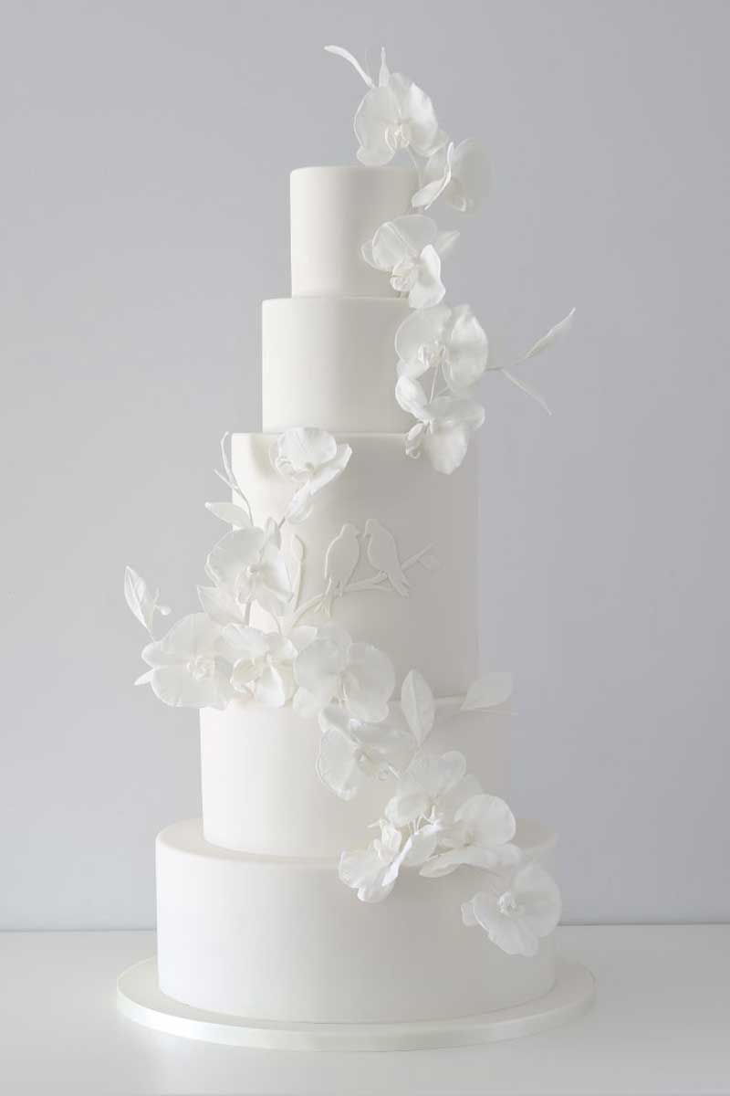 White wedding cake with orchid sugar flowers