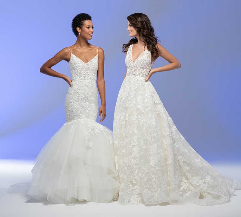 Women model two bridal gowns; 1 that is a mermaid skirt and the other that is fit and flare
