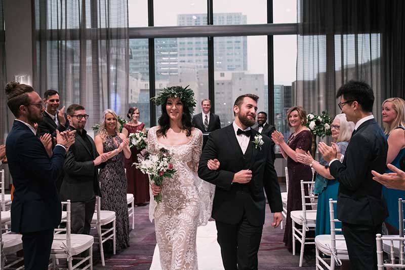 Couple walks down aisle at hotel wedding venue J. Powers