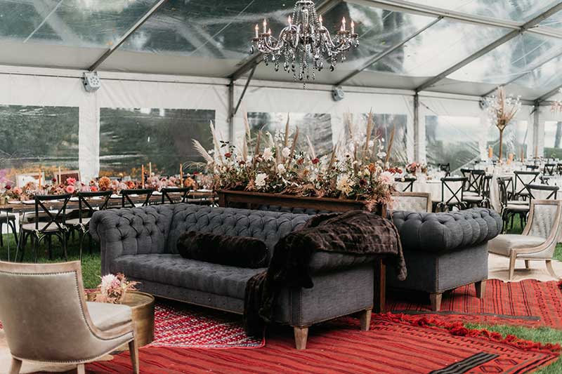 Wedding lounge with red carpet and black couches