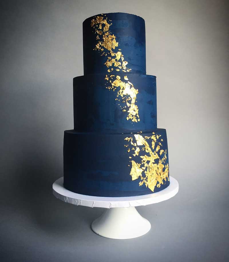 Navy blue 3-tier wedding cake with gold metallic flakes 