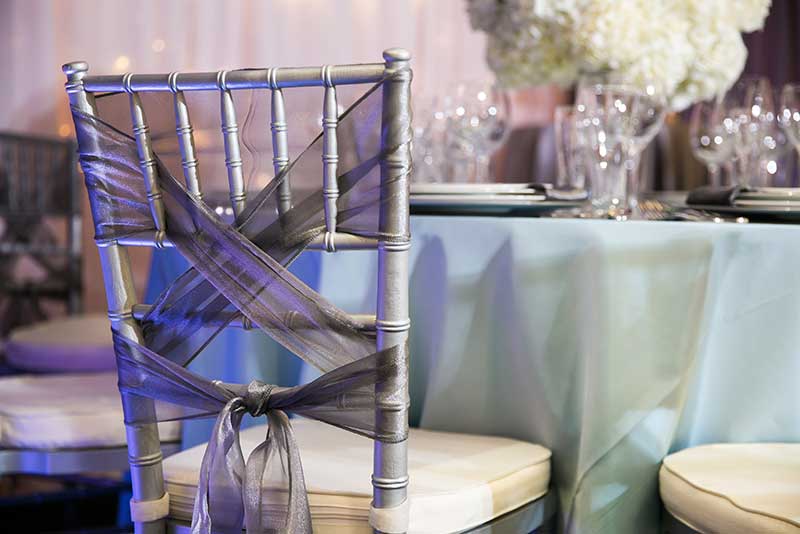 Gold chivari wedding chairs with gray bow