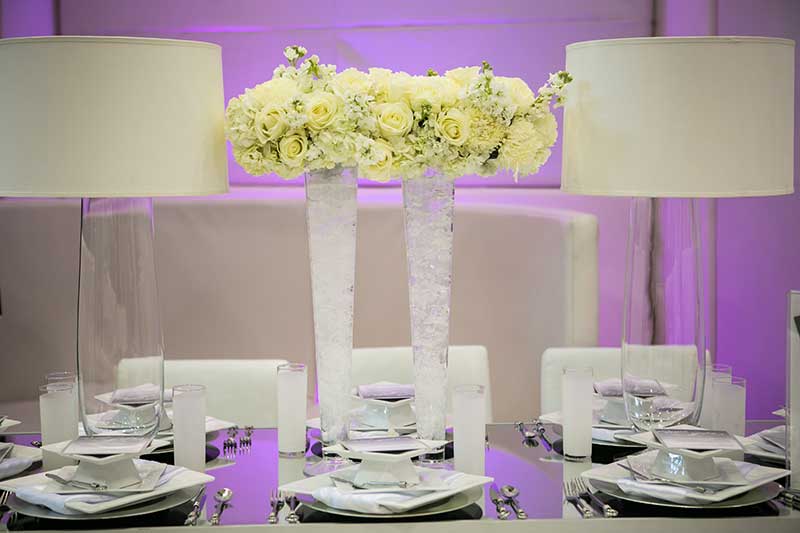 White and clear vase with yellow and white rose floral in wedding centerpiec3