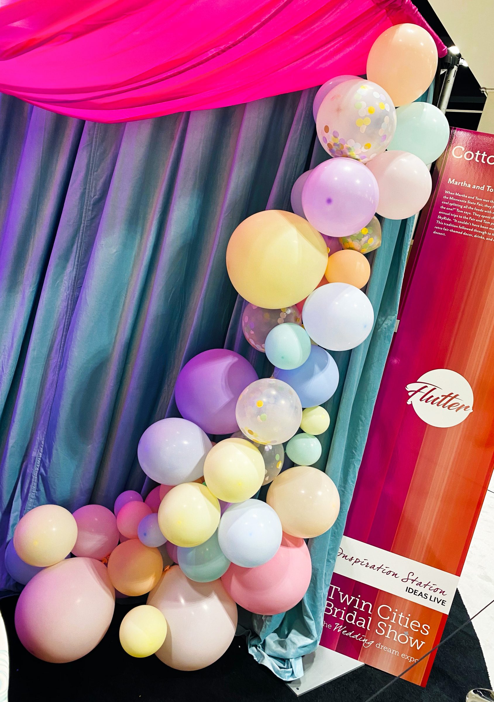 Light pink, blue, and yellow pastel balloon installation for wedding