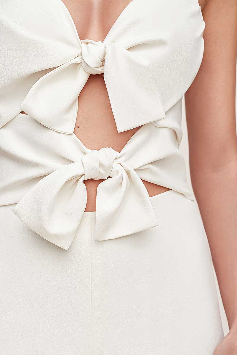 White jumpsuit with two large bows in front 