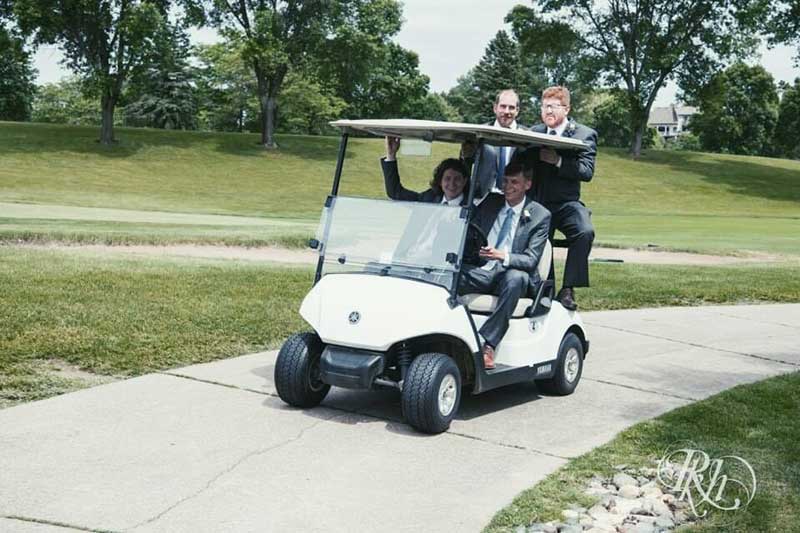 Groomsmen ride on golf cart at Oak Glen Golf Club