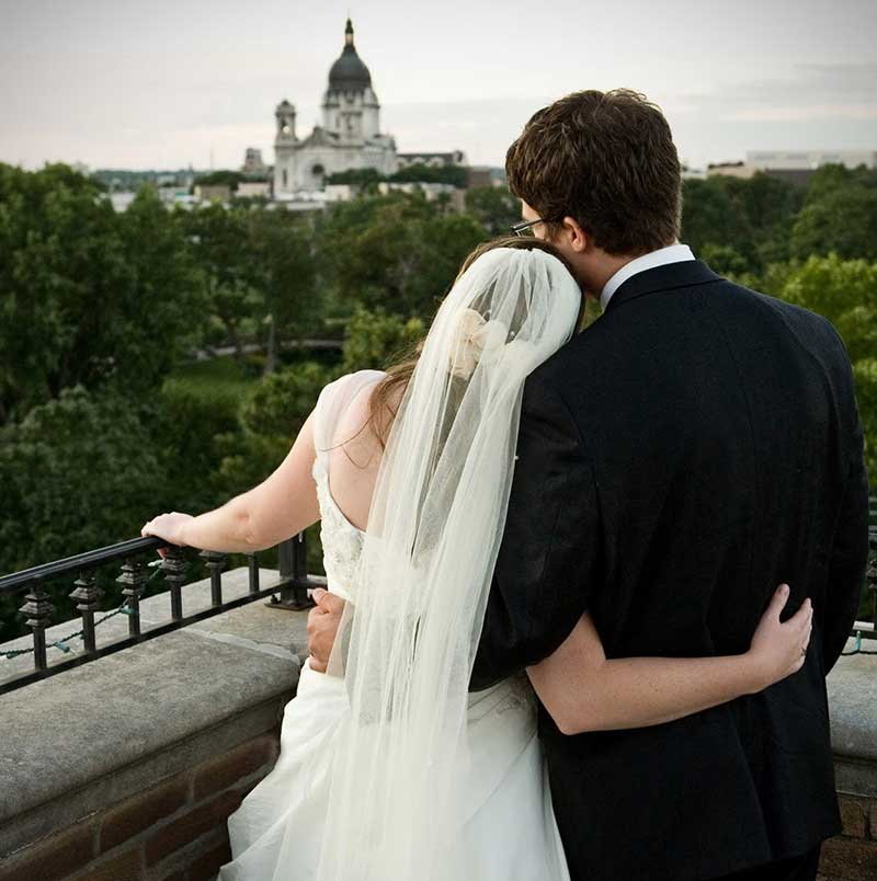 Couple looks over balcony at Minneapolis wedding venue