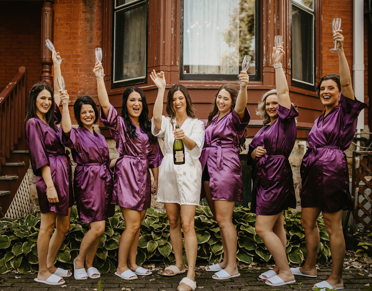 Bride and bridesmaids pop champagne