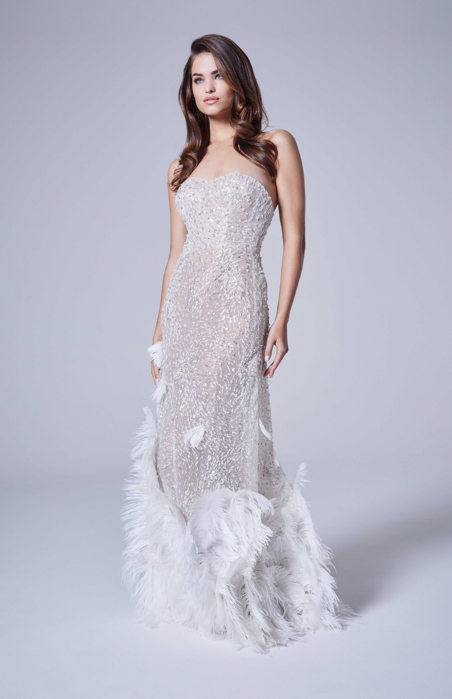 Sequin bridal gown with white feathers on bottom by Nicole + Felicia Couture