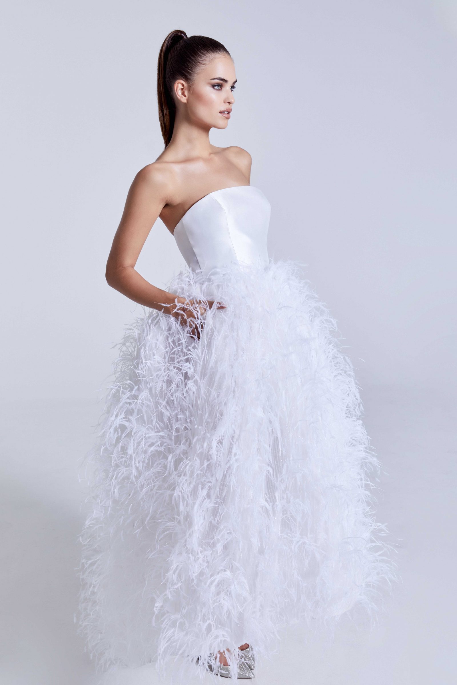 Simple strapless top bridal gown with feathered skirt
