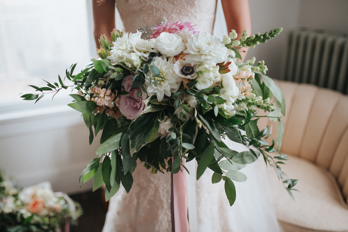 Dramatic bridal bouquet with greenery and anemones