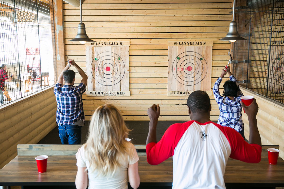 Group of people throw axes